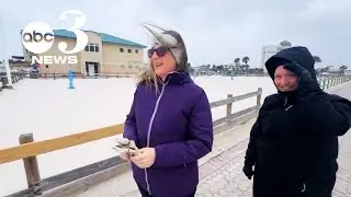 Snow falls at Pensacola Beach, Florida in rare winter storm