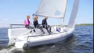 Two Girls and a Guy Manage a Small Yacht During a River Trip in Early Autumn. Dynamic Shot with ...