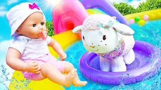 Baby Annabell doll & a toy lamb. The baby doll goes for a walk. Doll videos for girls.