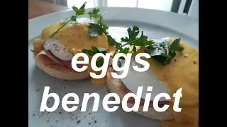 Eggs Benedict, classic New York Brunch with ham, eggs, English muffin and hollandaise