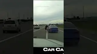 Suspect clings to moving car while fleeing police