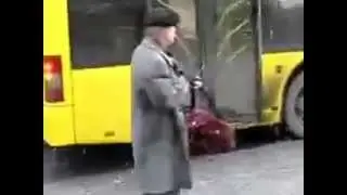 Crazy old man threatens a bus with a machine gun