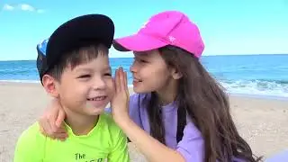 Kids are playing playing in the sand with  toys.