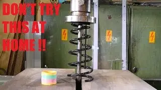 Crushing car spring with hydraulic press