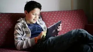 Young Teenager Playing Games On Tablet Computer Hd. Stock Footage