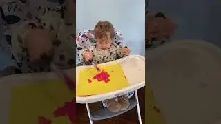 Cute baby tries to eat paint