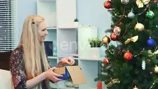 Close Up of Joyful Woman Hangs Toys on Christmas Tree Taking Them From the Box | Stock Footage -...