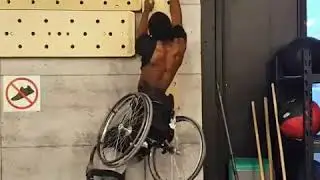 Guy in Wheelchair Takes off Shirt While Climbing Campus Board - 989209-1