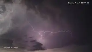 Lightning illuminates dark, swirling clouds - StormStock