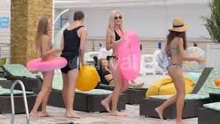 Group of Young People in Swimsuits with Inflatable Ring on Holiday in Summer | Stock Footage - E...