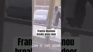 Francis Ngannou breaks the glass of a shop entrance door