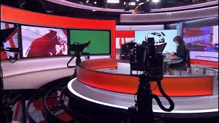 Green catwalk screen on BBC News