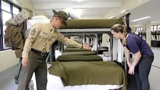 U.S. Marine tries to teach reporter how to make a military-style bed