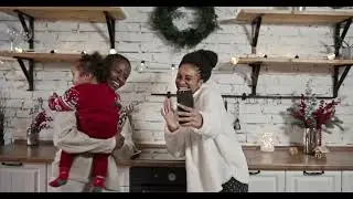 Two Woman and a Child Having Fun Dancing While Having a Video Call Through the Smartphone