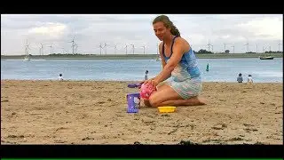 ABDL building a sand castle on the beach, playing in the sand