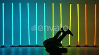 Professional Breakdancer Performs Complex Spins on the Floor. Silhouette of a Man Dancing Agains...