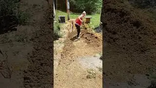 Wife Fills in ditch with well pipe while I build well house