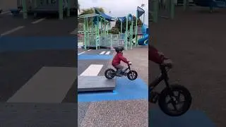 Little biker goes wild on the jungle gym