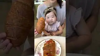 Baby eats her first croissant