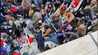 Video shows Trump mob beating the limp body of officer with American flags and batons