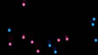 Pink and Blue Glowing Orbs Floating around on a Black Background